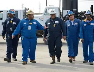 A group of Veolia employees walk through a facility