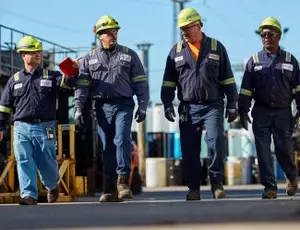 Four Veolia employees walk together through a facility