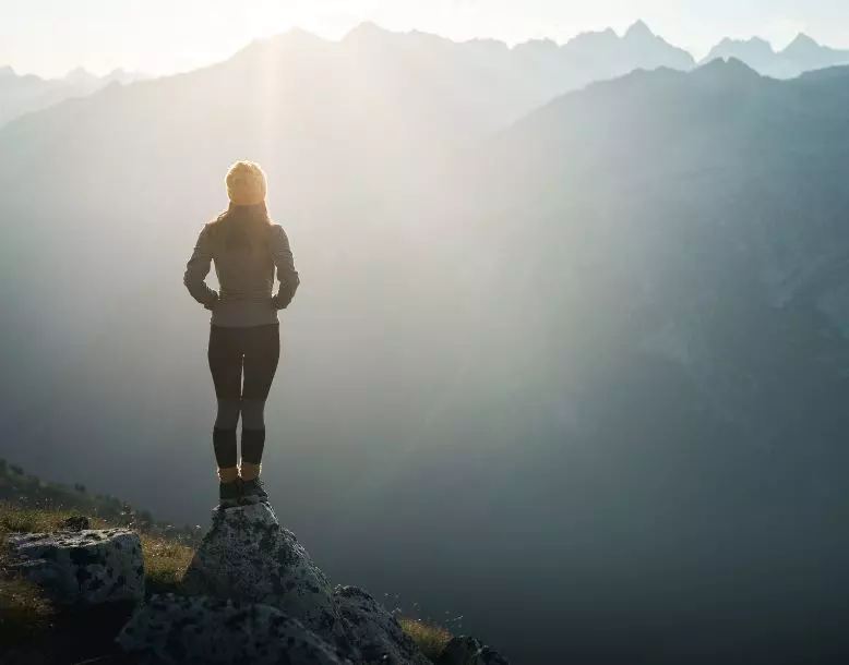 A woman stands in nature