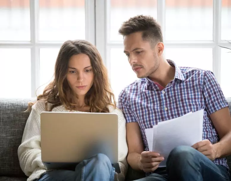 A couple looks at bills