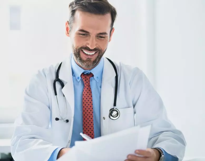 A doctor reviews paperwork