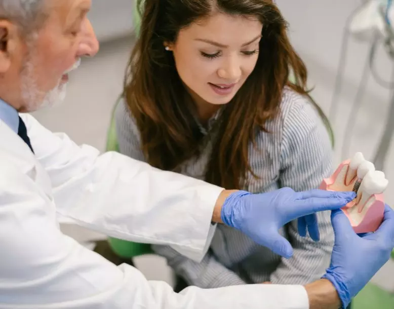 A person talks with their dentist