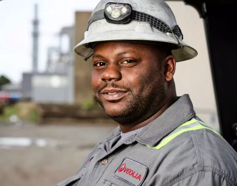 A Veolia employee smiles at the camera