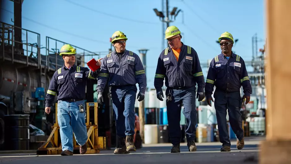 Four Veolia employees walk together through a facility