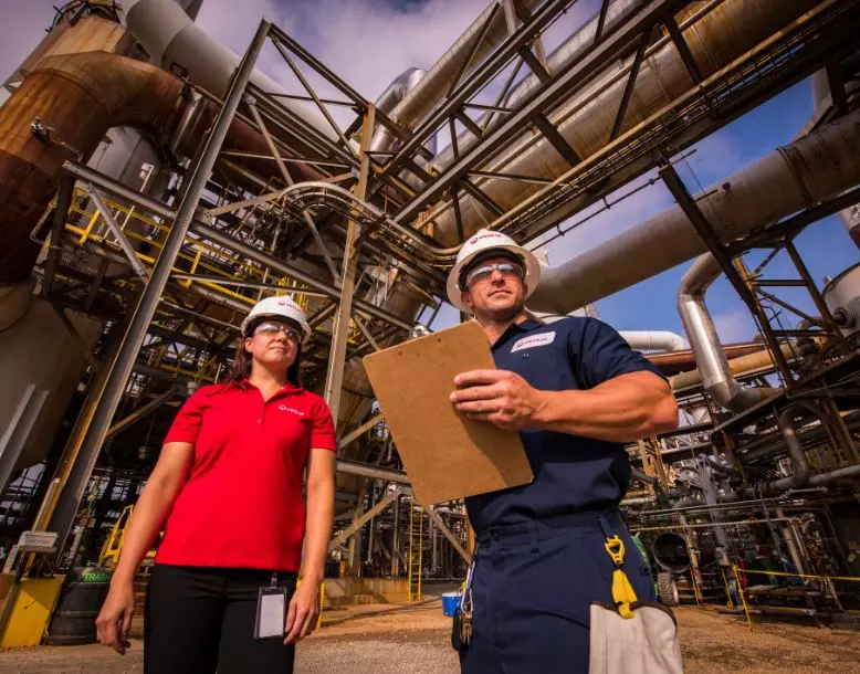 Two Veolia employees stand in a facility