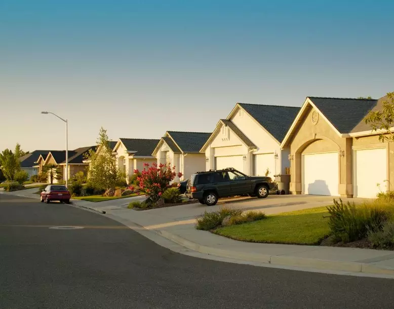 A suburban neighborhood of homes with cars in the driveways